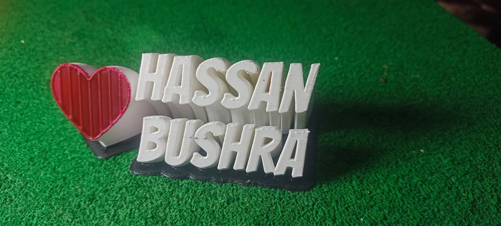 Personalized 3D-printed name art reading HASSAN and BUSHRA with a red heart accent